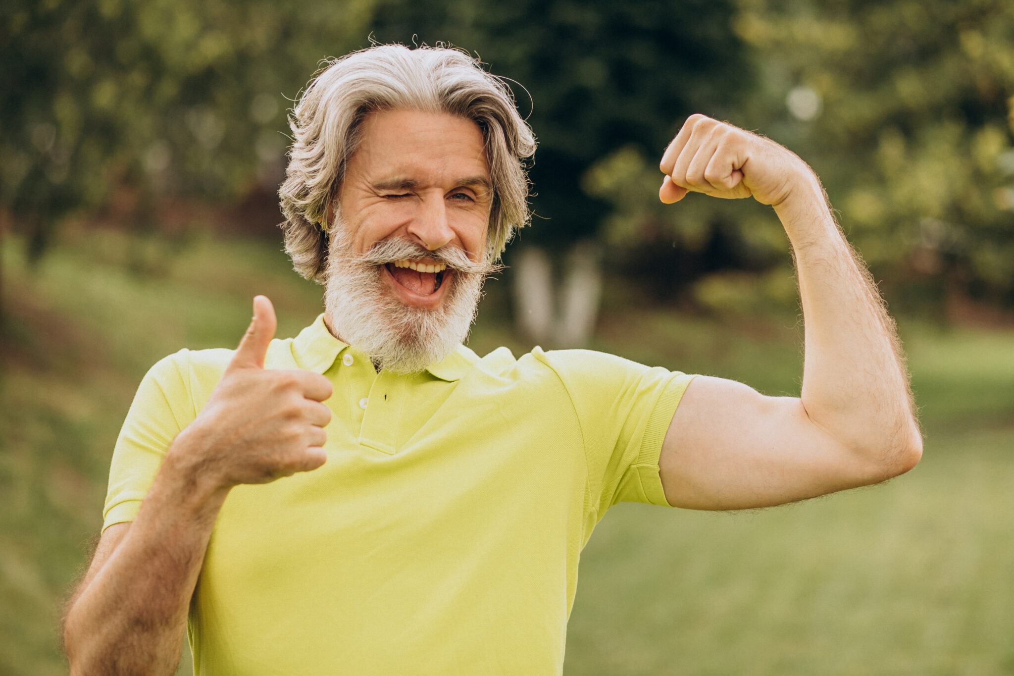 Middle aged sportsman pointing on his biceps